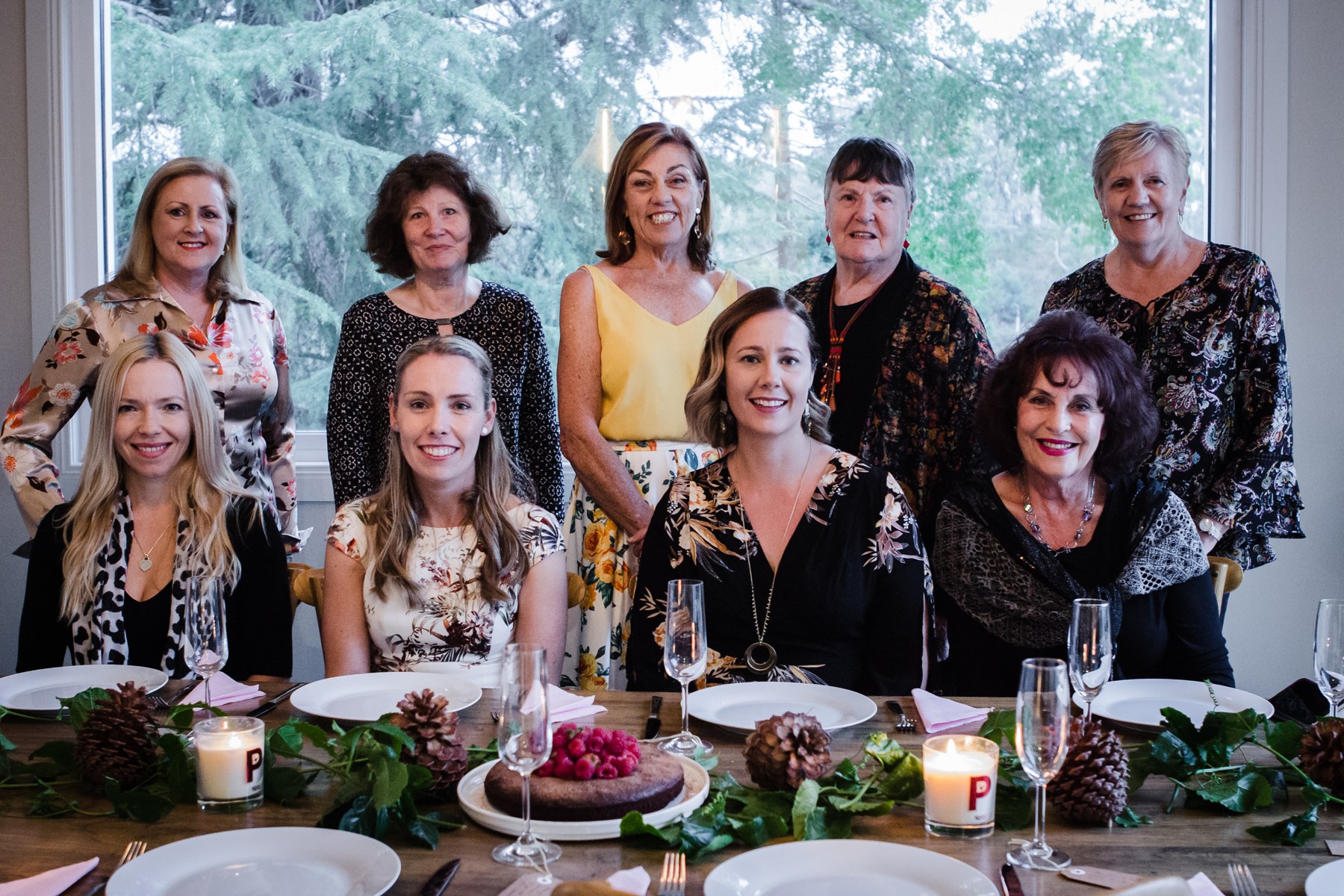 Retreat guests gathered around a beautifully set dining table in Daylesford